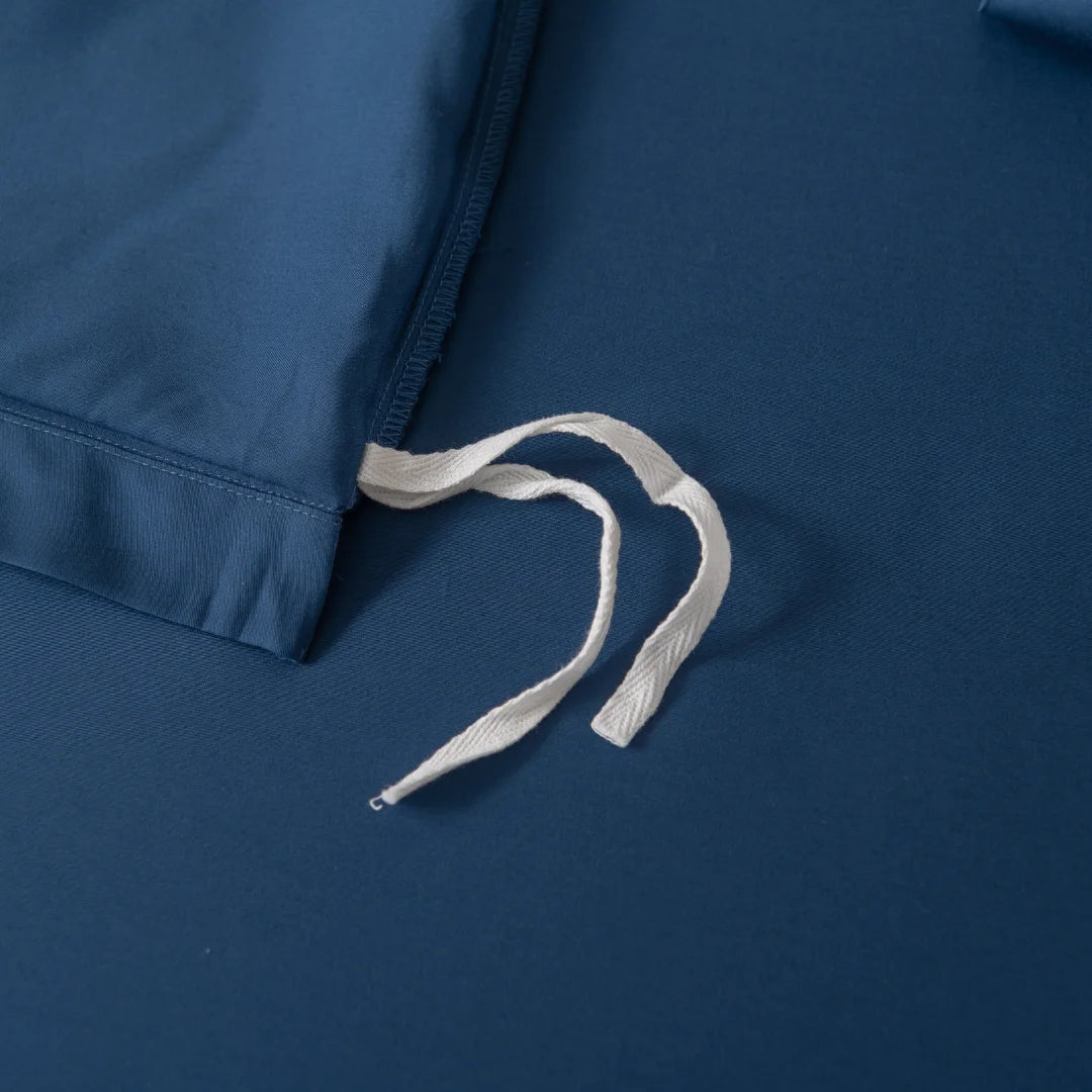 Close-up of Linenly's Bamboo Quilt Cover - Midnight, showcasing its silky texture and precise stitching, with a white drawstring on top revealing its supreme softness.