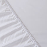 Close-up of the Linenly Bamboo Fitted Sheet - White, featuring deep sides with gathered elastic on one edge and smooth, luxurious softness for ultimate comfort.